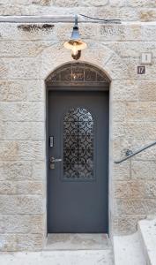 a black door with a window on a brick building at Old City Boutique Hotel in Jerusalem