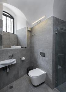 a bathroom with a toilet and a sink and a shower at Old City Boutique Hotel in Jerusalem