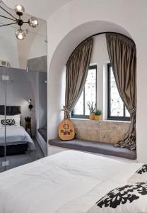 a bedroom with a large bed and a large mirror at Old City Boutique Hotel in Jerusalem