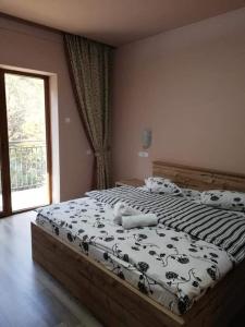 OrlatにあるPensiune Marginimea Sibiuluiの窓付きのベッドルームの大型ベッド1台