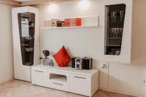 a kitchen with a white cabinet with a microwave on it at FeWo B50 in Beckingen