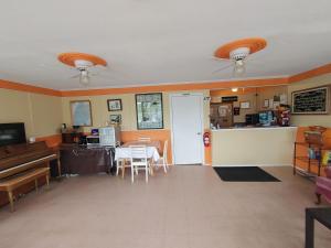 a living room with a table and a kitchen at Highland Motel in North Sydney +20 photos
