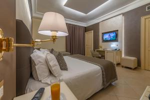 Giường trong phòng chung tại Vittorio Emanuele Boutique Hotel