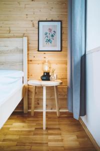 a small table in a room next to a bed at Gorska Roža in Log pod Mangartom