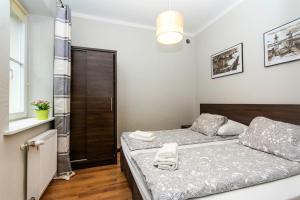 Posteľ alebo postele v izbe v ubytovaní RentApart Centrum