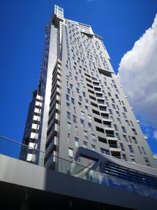un grand immeuble d'appartements blanc avec un ciel bleu dans l'établissement Sea Towers "Sweet Dream", à Gdynia