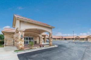 a parking lot in front of a hotel at Eagle Ford Inn in Floresville