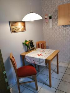 a dining room table with a table and two chairs at Am Waldrand in Schüttorf