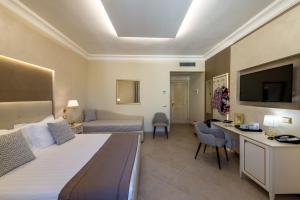 a hotel room with a bed and a tv at Vittorio Emanuele Hotel in Sciacca +156 photos