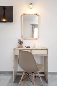 a desk with a chair and a mirror at Casa Verde Di Naxos in Naxos Chora