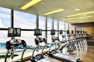 a row of cardio machines in a gym with windows at Altira Macau in Macau