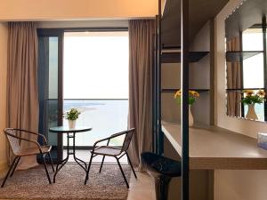 a room with a table and chairs and a window at Imperio,Res - Stylish -- Magnificent -- Seaview in Melaka