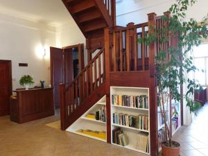 a book shelf under a staircase with books at Pribina Penzión in Nitra