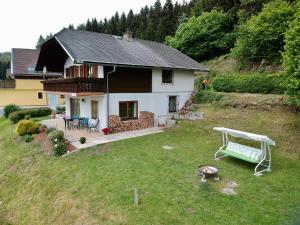 een huis met een tuin met een grill ervoor bij Ferienhaus Karawankenblick in Wurzen