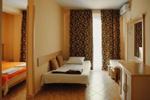 a small room with two beds and a window at Villa Marija - Izgrev in Star Dojran +39 photos