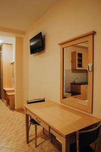 a room with a wooden table and a mirror at Villa Marija - Izgrev in Star Dojran