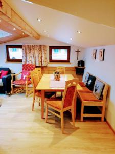 a dining room with a wooden table and chairs at Haus Silberwang in Sankt Gallenkirch