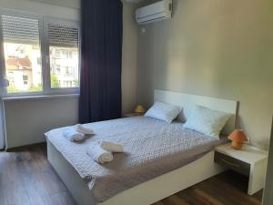a bedroom with a bed with towels on it at Danny apartment in Burgas City