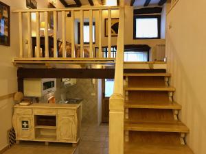 a loft bed in a tiny house at Apartamento Puerta Grande in Candelario +17 photos