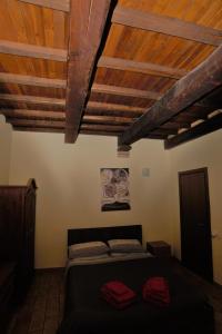 a bedroom with a bed and wooden ceilings at Via della Posterna in Spoleto