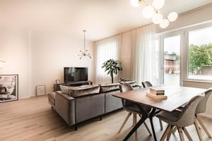 a living room with a couch and a table at Sleep Inn Wehrhahn Suites in Düsseldorf