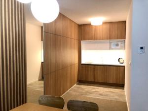 a dining room with wood paneling and a microwave at Hrebienok C217 in Starý Smokovec