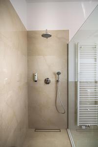 a bathroom with a shower with a shower head at Sleep Inn Wehrhahn Suites in Düsseldorf