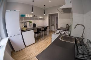 a kitchen with white appliances and a black counter top at Miraua 1 in Gdańsk