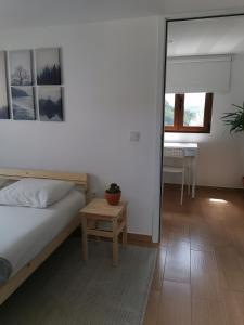 a bedroom with a bed and a table and a desk at Casa Mendes Lopes in Celorico de Basto +42 photos