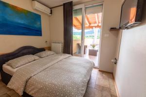 a bedroom with a bed and a large window at ANGELO in Koper