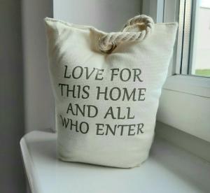 a white pillow with love for this home and all who enter at U Jagódki in Warpuny