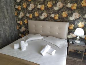 a white bed with two pillows on top of it at Apartment Julia in Paralia Katerinis