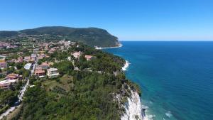 an aerial view of a village on a cliff next to the ocean at Amare Sirolo in Sirolo