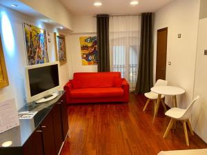 ボローニャにあるNel Sole monolocaleのリビングルーム(赤いソファ、テレビ付)