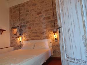 a bedroom with a white bed with a brick wall at Amazing View in Kokkala