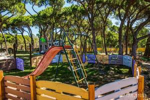 a playground with a slide in a park at Quinta Vita - Vila Limao in Almancil