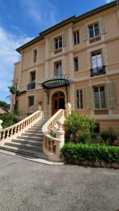 a large building with stairs in front of it at DAJO Castel Lina in Cap d'Ail