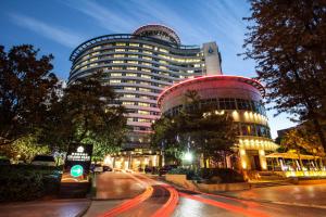 a large building with a red top on a city street at Grand Park Kunming in Kunming