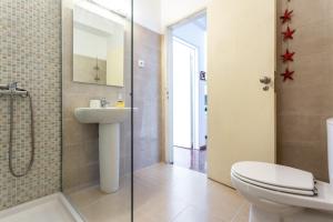 a bathroom with a toilet and a sink and a shower at Sea View Fairy Tale in Faro +12 photos