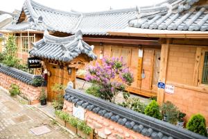 an asian style building with plants and flowers on it at Starlight Rest Area in Jeonju