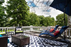 a patio with chairs and an umbrella and a table at The Nordic Pineapple Bed and Breakfast in Saint Johns