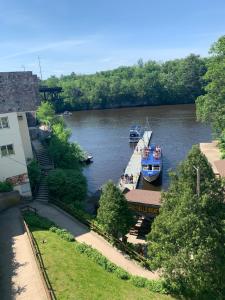 two boats are docked at a dock on a river at Colonial motel in Wisconsin Dells