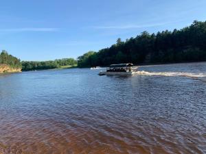 a boat in the water on a river at Colonial motel in Wisconsin Dells