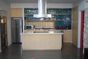 a kitchen with a counter and a refrigerator at Camelot in Kingscote