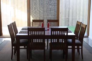 a dining room table with chairs and a table and a table and chairsktop at Camelot in Kingscote