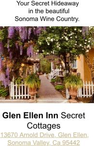 a street scene with flowers and a sign at Glen Ellen Inn Secret Cottages in Glen Ellen