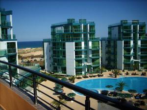 a view of a resort with a pool and some buildings at Hotel Venecia in Primorsko