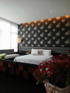 a hotel room with a bed and a wall with plates at Twin Galaxy Residences in Johor Bahru