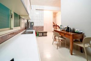 a kitchen with a table and a sink in it at Wind Blown Homestay in Hualien City