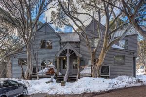 a gray house with a car parked in front of it at Kummonin in Dinner Plain